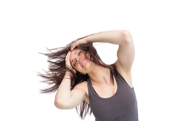 Pretty young brunette tossing her hair — Stock Photo, Image