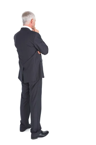 Thoughtful businessman standing back to camera — Stock Photo, Image