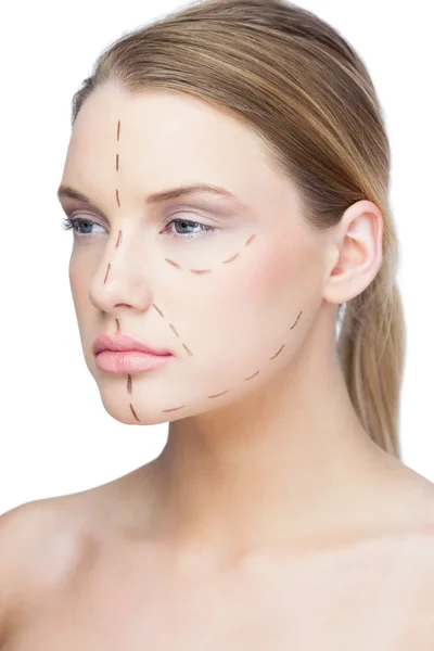 Serious pretty blonde with dotted lines on the face — Stock Photo, Image