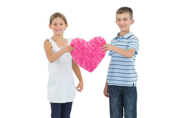 Children holding heart shaped soft toy — Stock Photo, Image