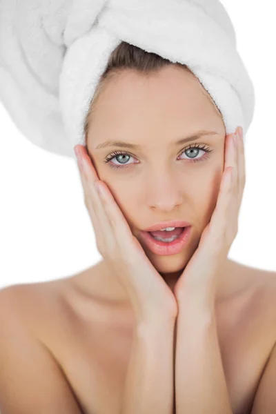 Shocked brunette drying her hair looking at camera — Stock Photo, Image