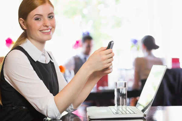 Happy businesswoman sending a text — Stock Photo, Image