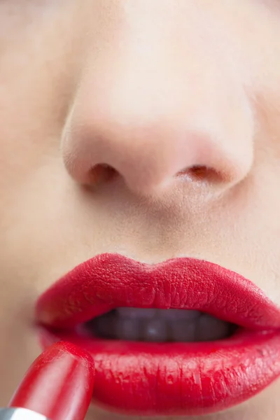 Extreme close up on sensual red lips being made up — Stock Photo, Image