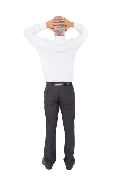 Businessman standing back to camera with hands on head — Stock Photo, Image