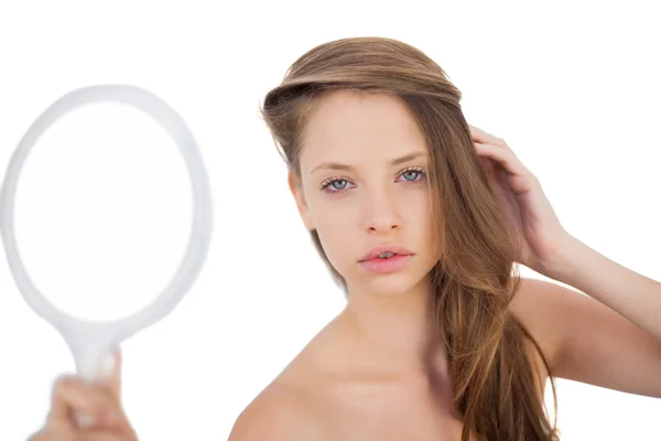 Calm brunette model posing holding a mirror — Stock Photo, Image