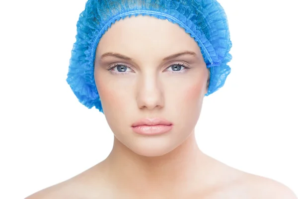 Serious pretty model wearing blue surgical cap — Stock Photo, Image