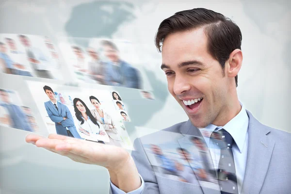 Pleased businessman looking at a picture stream — Stock Photo, Image
