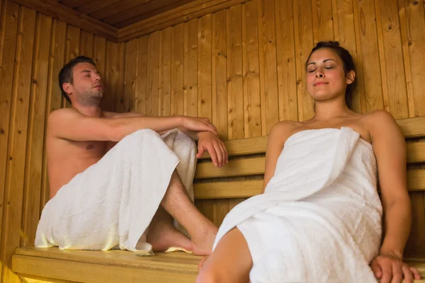 Happy couple relaxing in a sauna — Stock Photo, Image