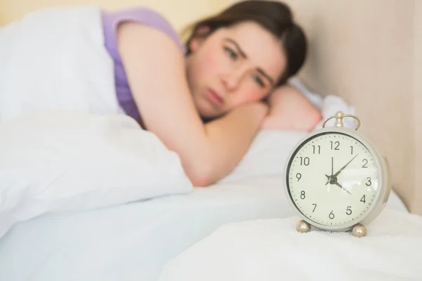 Exhausted girl waking up in her bed — Stock Photo, Image