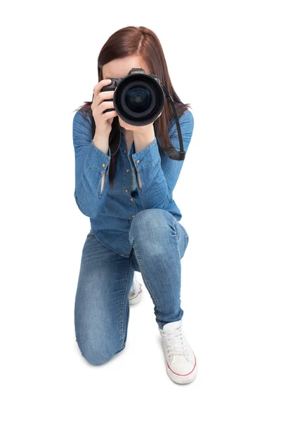 Pretty young photographer taking picture of camera — Stock Photo, Image