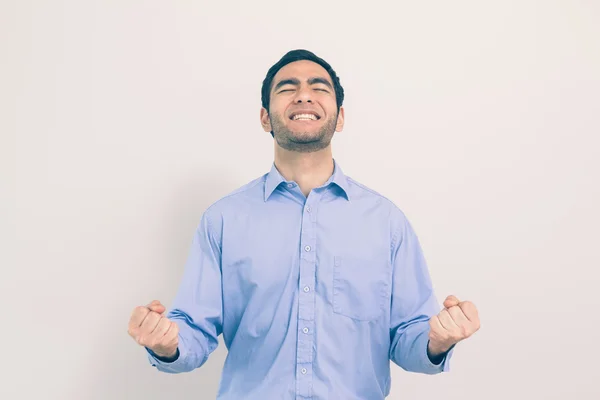 Victorious man standing clenching his fists — Stock Photo, Image