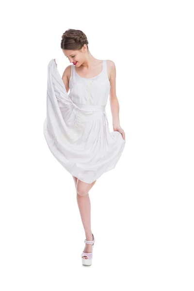 Smiling woman playing with her white summer dress — Stock Photo, Image