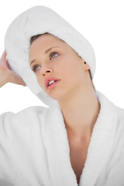 Contemplative brunette in bathrobe looking away — Stock Photo, Image