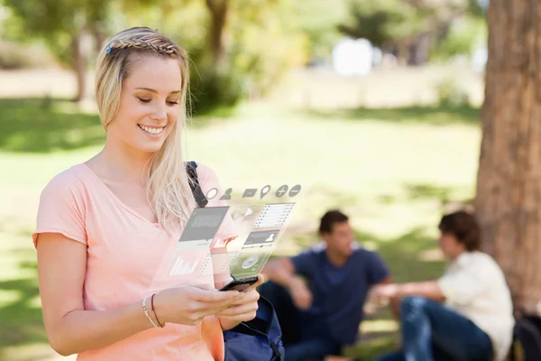 Pretty blonde working on her digital smartphone — Stock Photo, Image