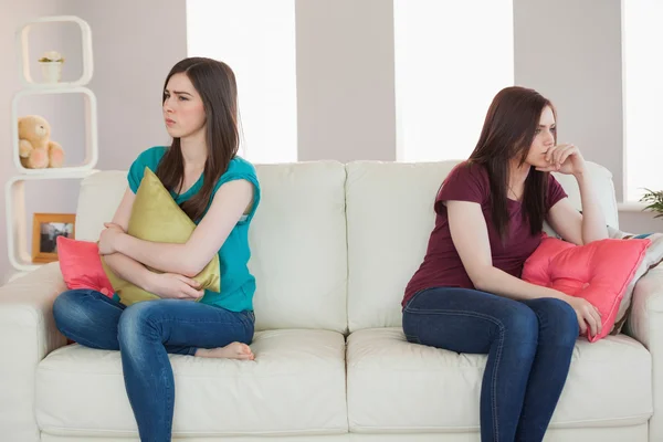 Two friends not talking to each other after fight on the sofa — Stock Photo, Image