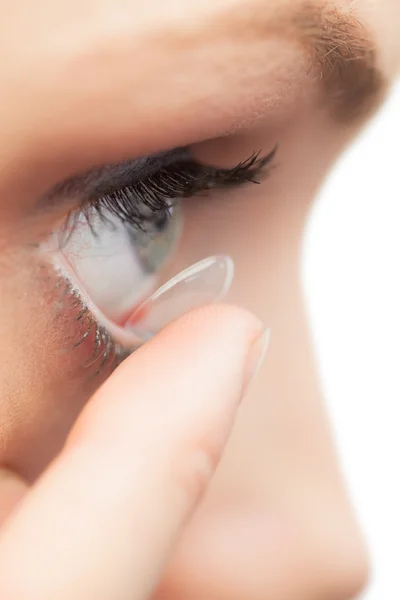 Extreme close up on pretty model applying contact lens — Stock Photo, Image