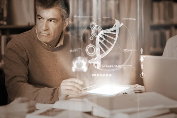 Mature student using futuristic hologram to learn science from tablet pc — Stock Photo, Image