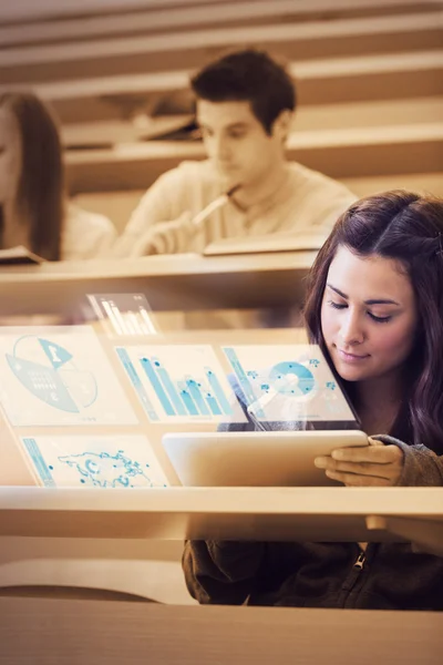 Estudiante bastante analizando gráficos en su computadora tableta futurista —  Fotos de Stock