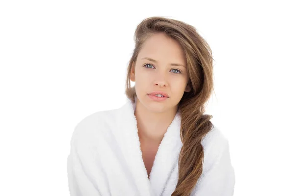 Attractive brunette in bathrobe looking at camera — Stock Photo, Image