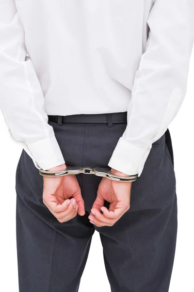 Закрыть глаза на молодого бизнесмена в наручниках — стоковое фото