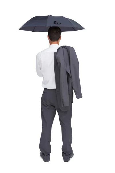 Businessman standing back to camera holding umbrella and jacket on shoulder — Stock Photo, Image