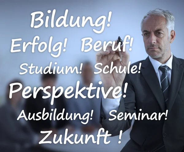 Uomo d'affari che scrive termini di apprendimento in tedesco — Foto Stock