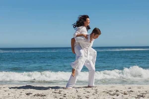 Woman sitting on man back and having fun — Stock Photo, Image