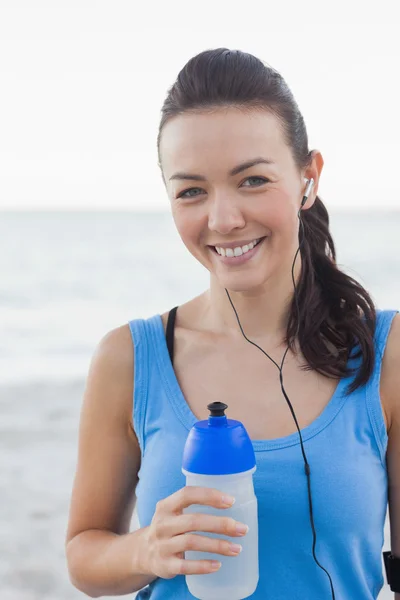 Smiling woman holding her bottle — Stock Photo, Image