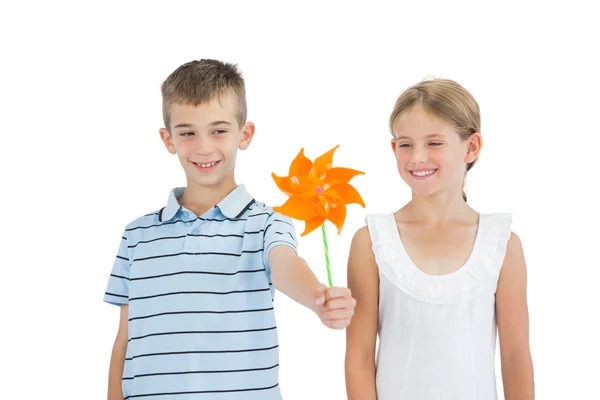 Brother and sister playing with pinwheel — Stock Photo, Image