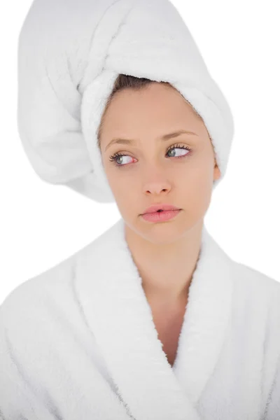 Thinking brunette in bathrobe looking away — Stock Photo, Image