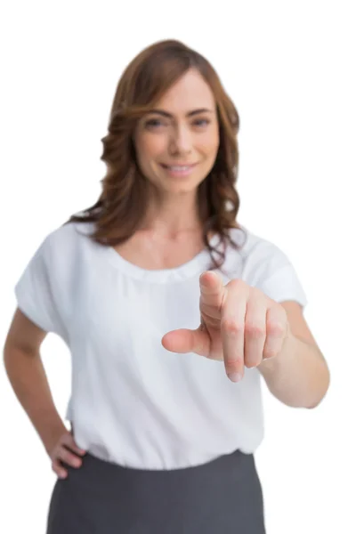 Attractive businesswoman looking and pointing at camera — Stock Photo, Image