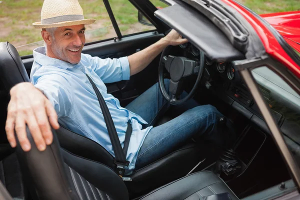 Cheerful handsome man posing in red convertible — Stock Photo, Image