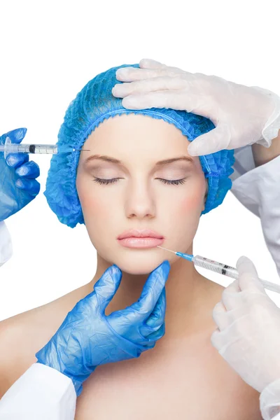 Surgeons making injection on peaceful blonde — Stock Photo, Image