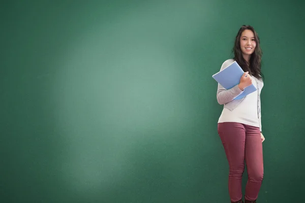 Smiling brunette holding notebook posing — Stock Photo, Image