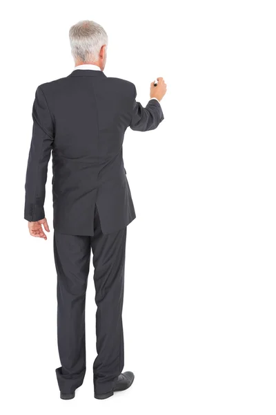 Rear view of businessman standing and writing — Stock Photo, Image