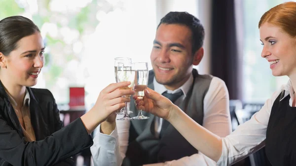 Smiling business people celebrating with champagne — Stock Photo, Image