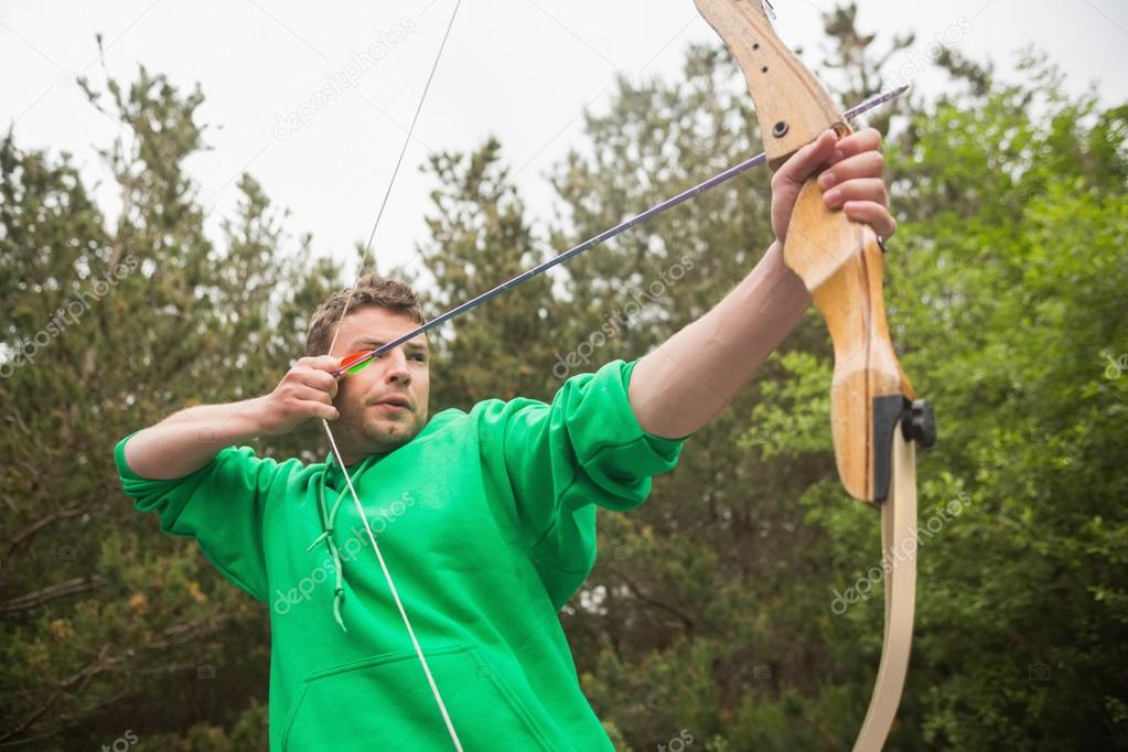 Concentrating man practicing archery — Stock Photo © Wavebreakmedia