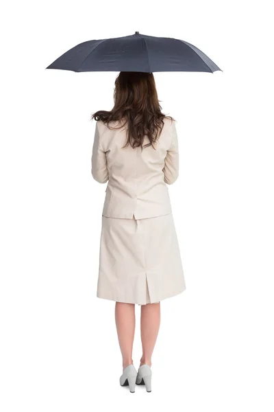 Rear view of classy businesswoman holding umbrella — Stock Photo, Image