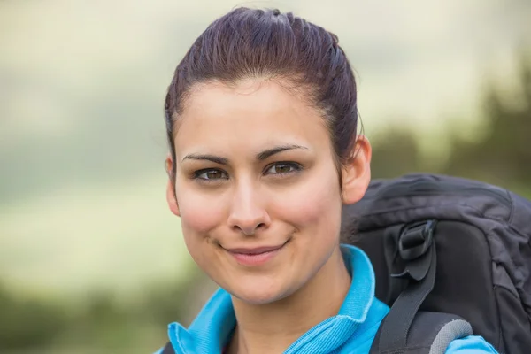 Female hiker with backpack smiling at camera — Stock Photo, Image