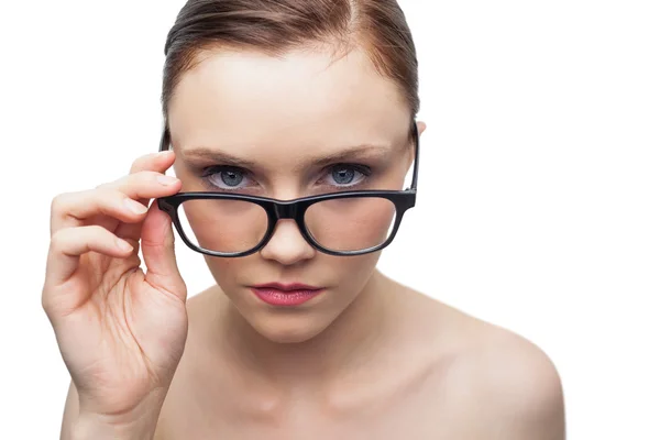 Serious clean model looking over her classy glasses — Stockfoto