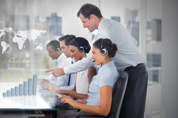 Call center employees at work on futuristic interfaces showing map and graph — Stock Photo, Image