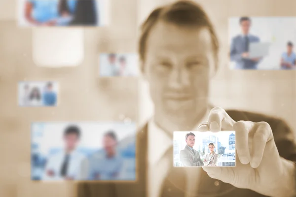 Content businessman picking a picture — Stock Photo, Image