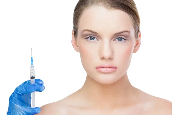 Serious beautiful blonde holding surgical needle — Stock Photo, Image