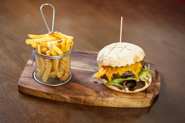 Närbild på en ost hamburgare och pommes frites — Stockfoto