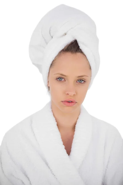 Serious brunette in bathrobe looking at camera — Stock Photo, Image