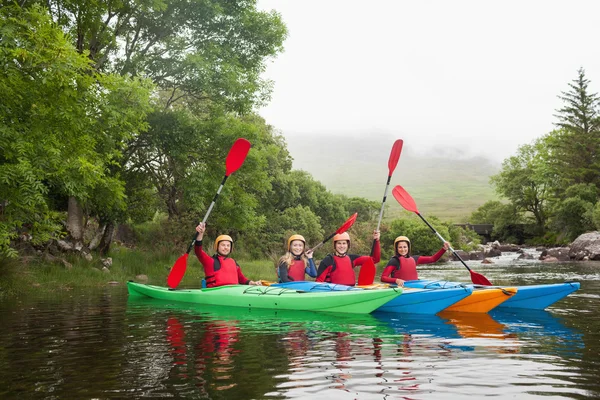 Friends kayaking together cheering at camera — Stock Photo, Image