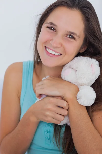 Young woman hugging a small teddy bear — Stock Photo, Image