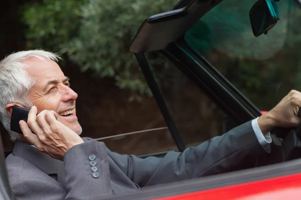 Happy businessman on the phone driving — Stock Photo, Image