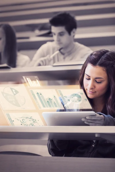 Student analysing graphs on her futuristic tablet computer — Stock Photo, Image