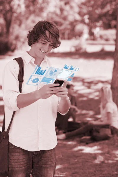 Smiling student working on his digital smartphone — Stock Photo, Image